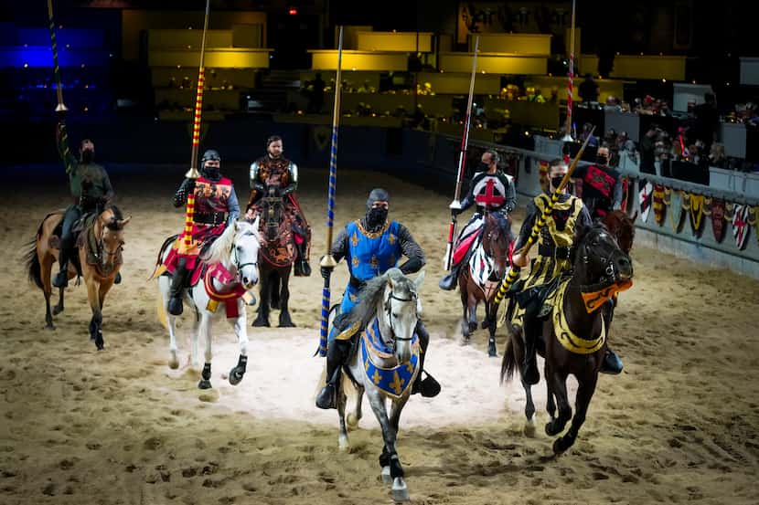 Knights wear face masks as they take part in a dinner show at Medieval Times on Thursday,...