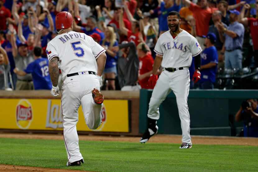Texas Rangers first baseman Mike Napoli (5) runs to first in a 3-run home run against the...