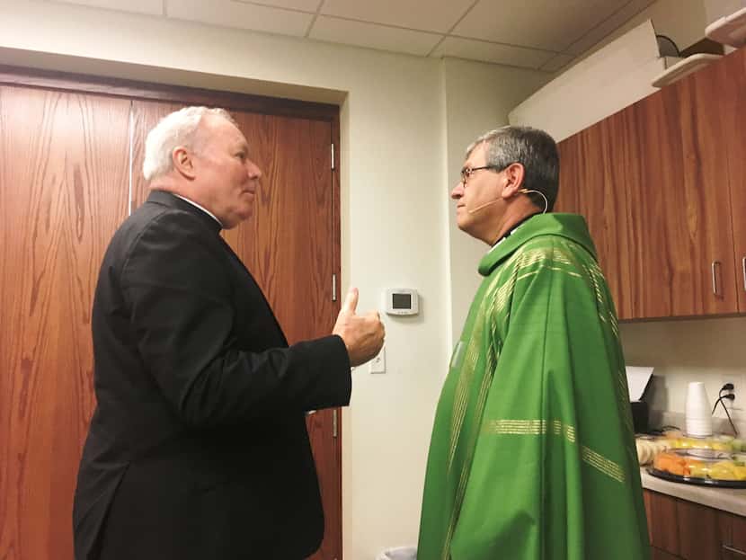 Dallas Bishop Edward Burns and the Rev. Martin Moreno, pastor at St. Cecilia Catholic...