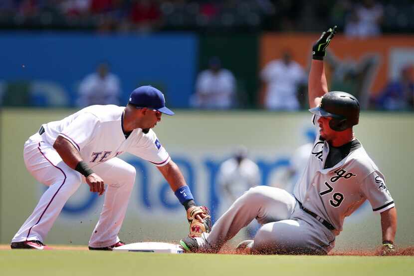 ARLINGTON, TX - AUGUST 20:  Jose Abreu #79 of the Chicago White Sox slides into second base...