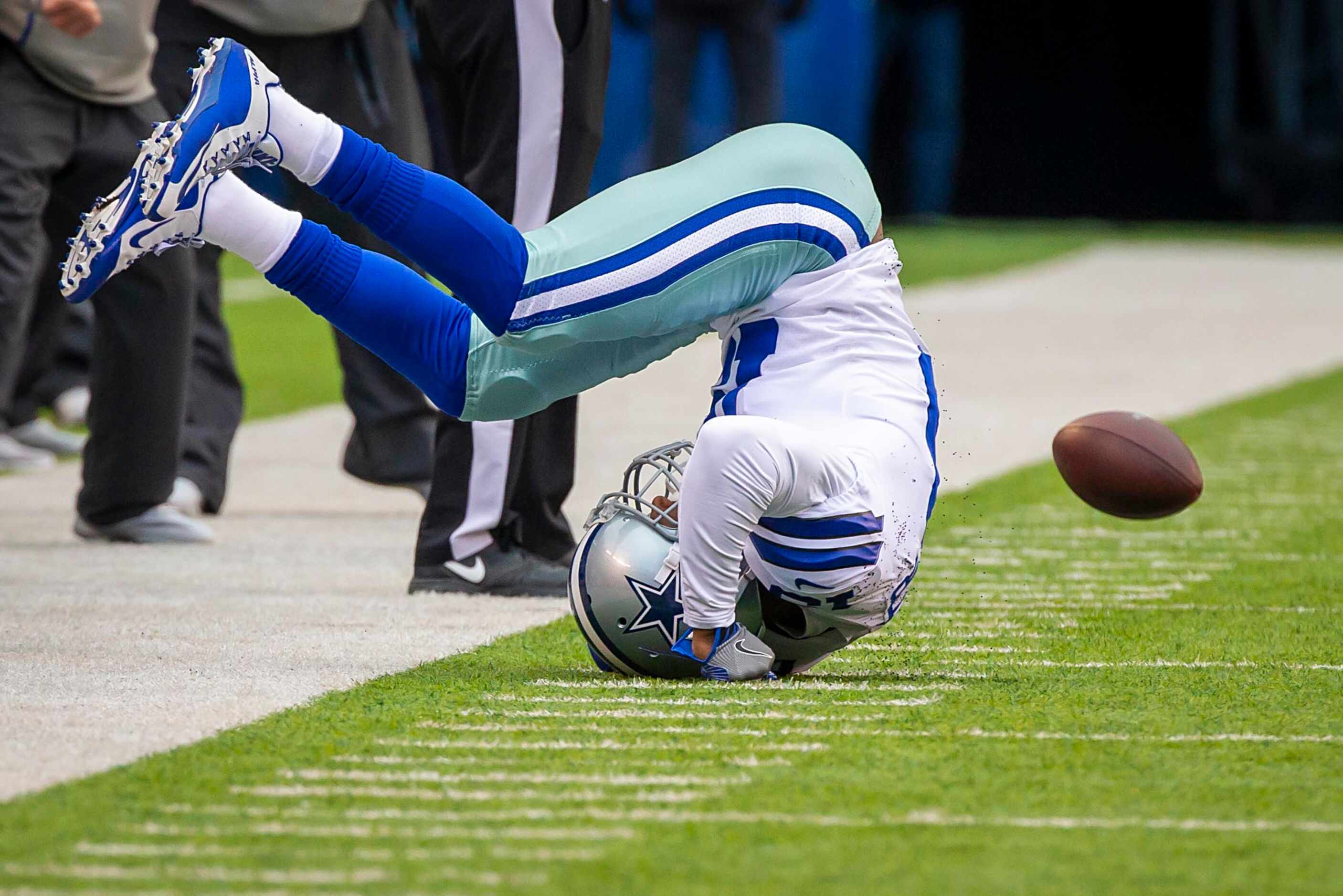 Dallas Cowboys wide receiver Amari Cooper (19) tumbles after failing to catch a pass during...