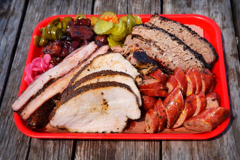 Panther City BBQ serves Hell's Half Acre, a tray full of brisket, pulled pork, sausage, pork...