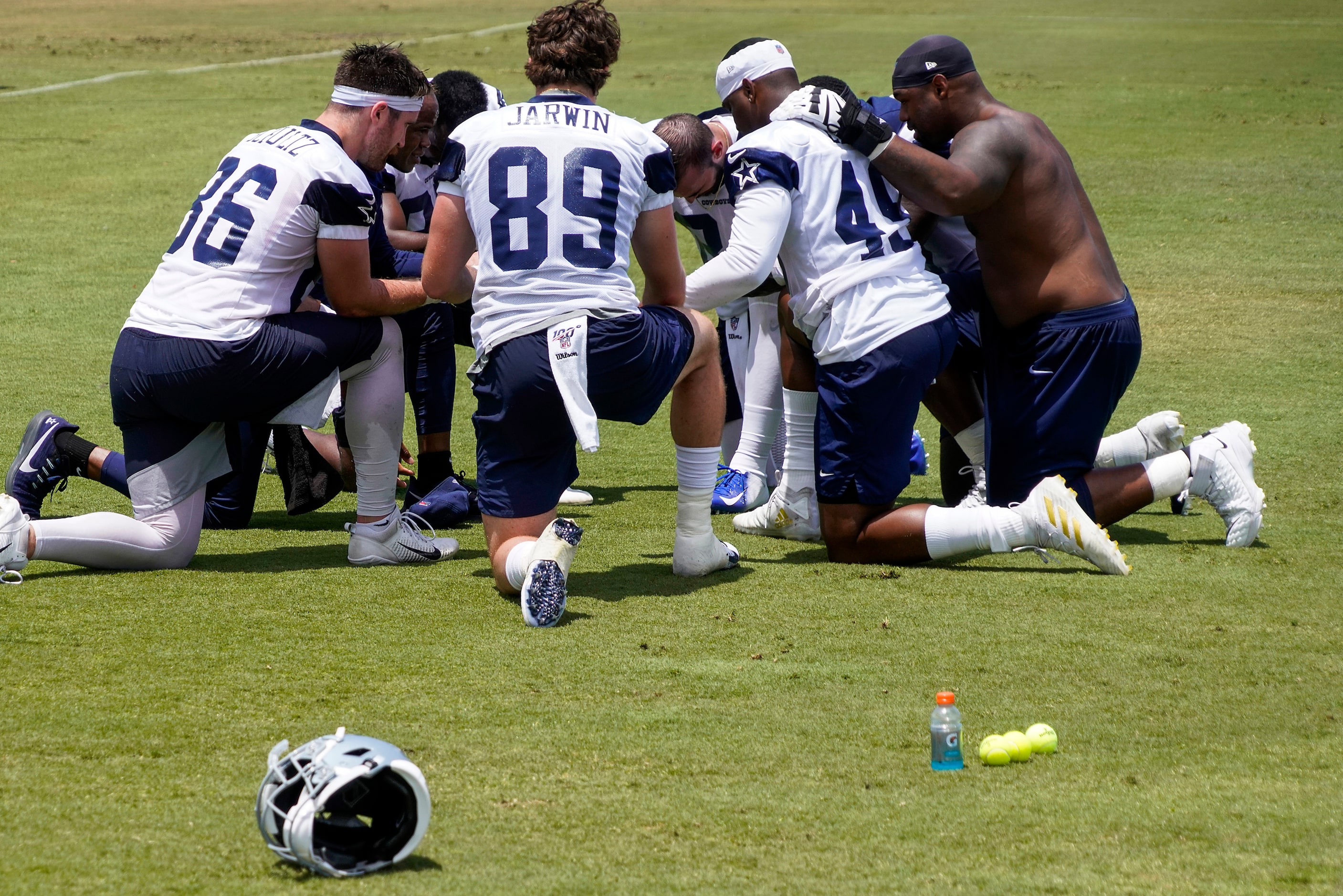 Dallas Cowboys tackle Tyron Smith (right) joins tight ends, including Dalton Schultz (86), ...