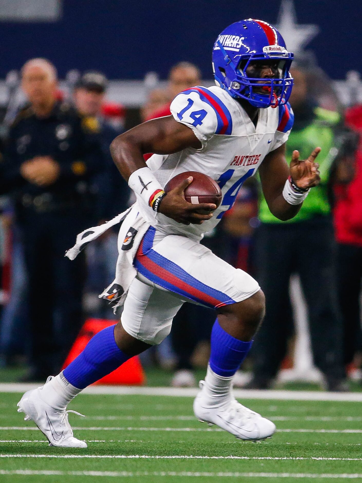 Duncanville's quarterback Chris Parson (14) runs in the second quarter of a Class 6A...