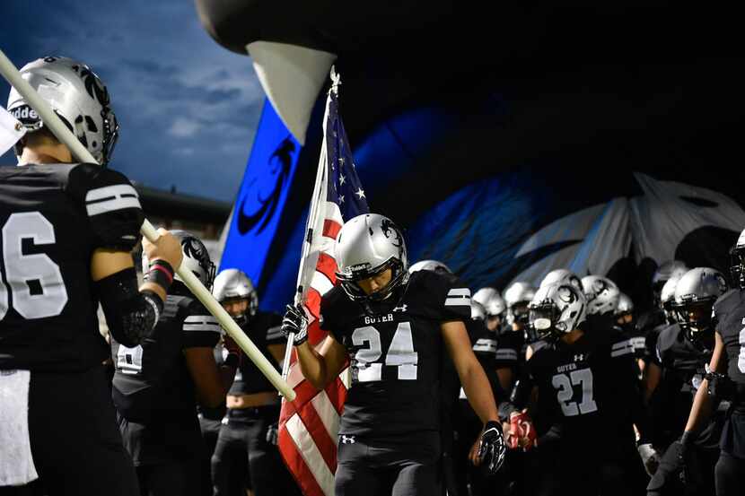 The Guyer High School football team pumps themselves up before they faceoff against Plano at...