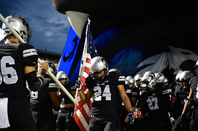 The Guyer High School football team pumps themselves up before they faceoff against Plano at...