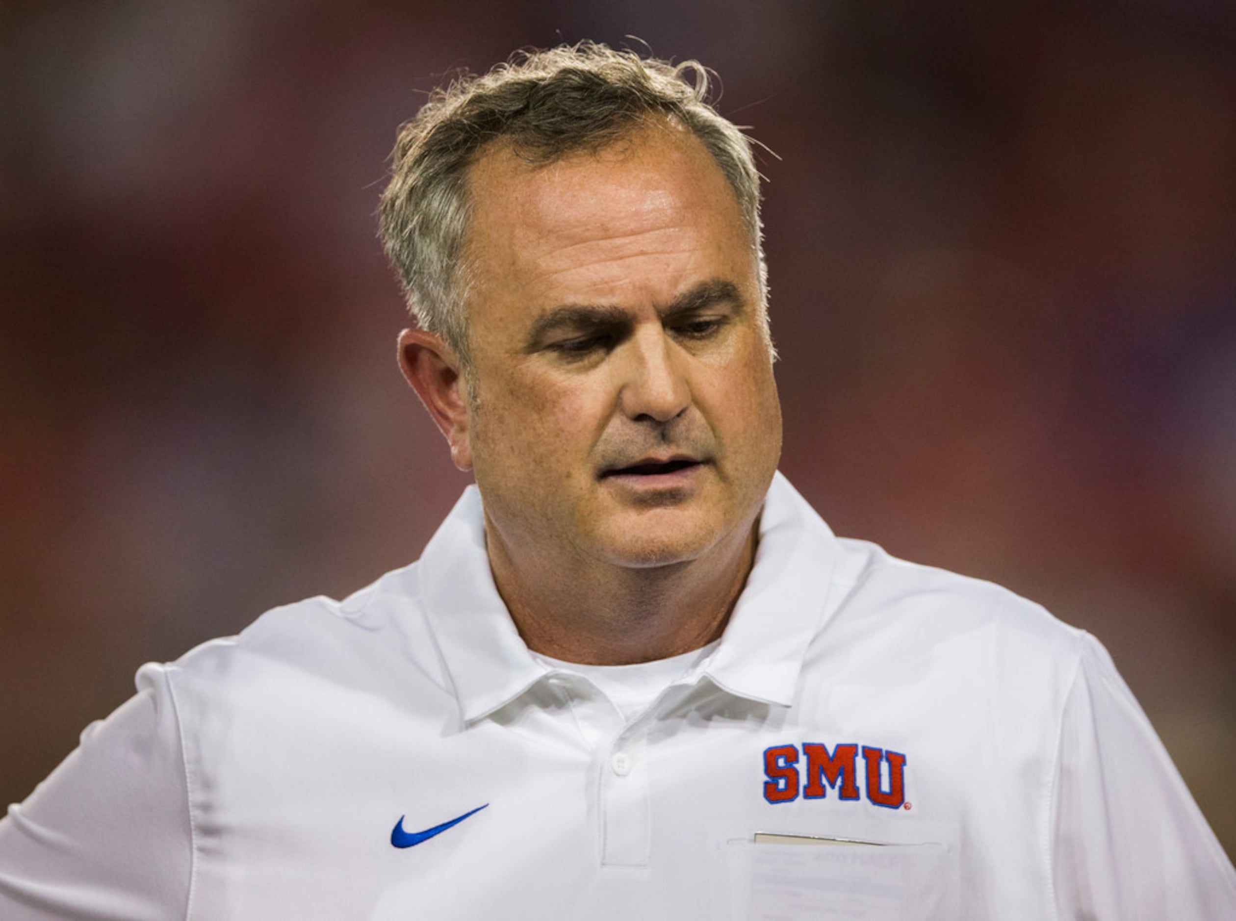 SMU Mustangs head coach Sonny Dykes watches as quarterback Jacob Oehrlein (18) is looked at...