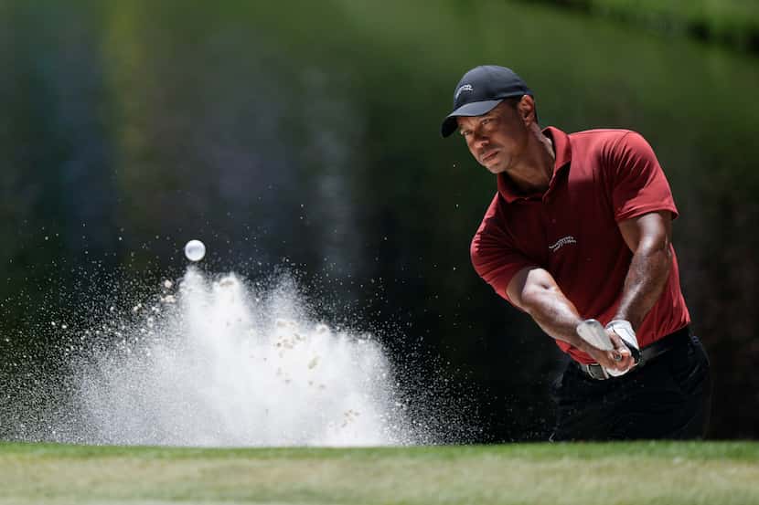 Tiger Woods hits from the bunker on the 16th hole during final round at the Masters golf...