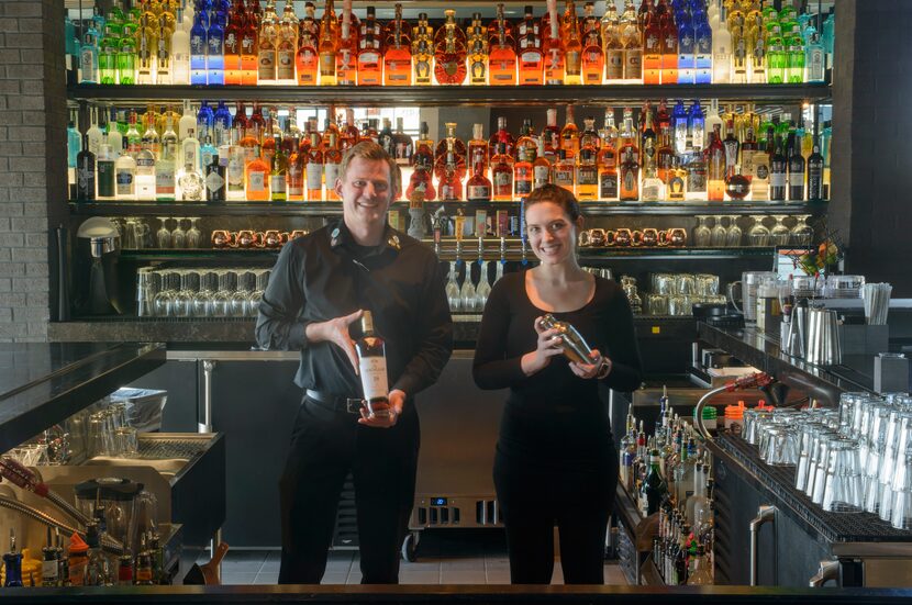 Head bartender Cody Hall, left and bartender Nicki Grady prepare to open Firebirds Wood...