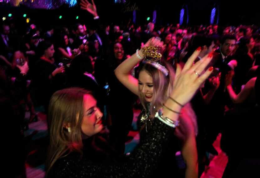 Partygoers dance the night away on the ballroom dance floor at the Statler Hotel's Black and...