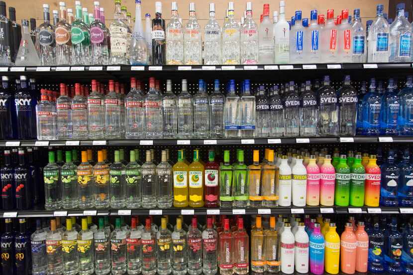 Bottles of liquor line the shelves at a liquor store