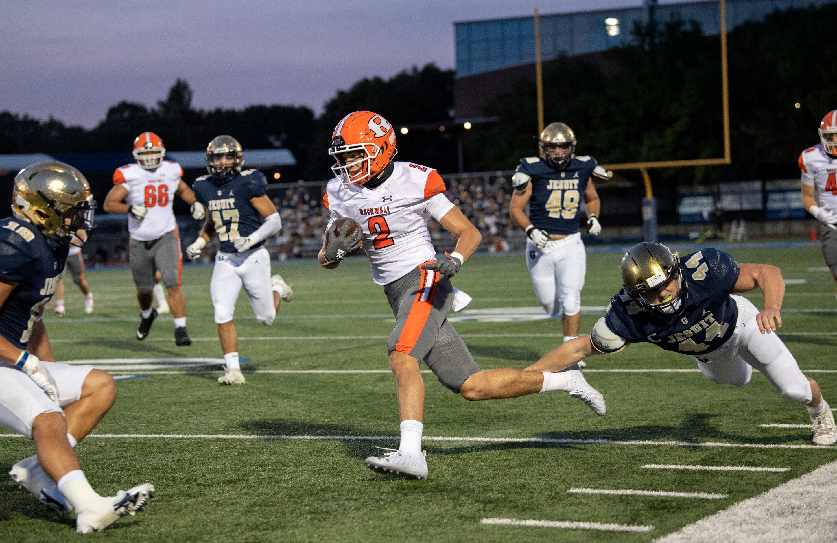 Rockwall senior wide receiver Brenden Bayes (2) runs past Jesuit senior linebacker Jack...