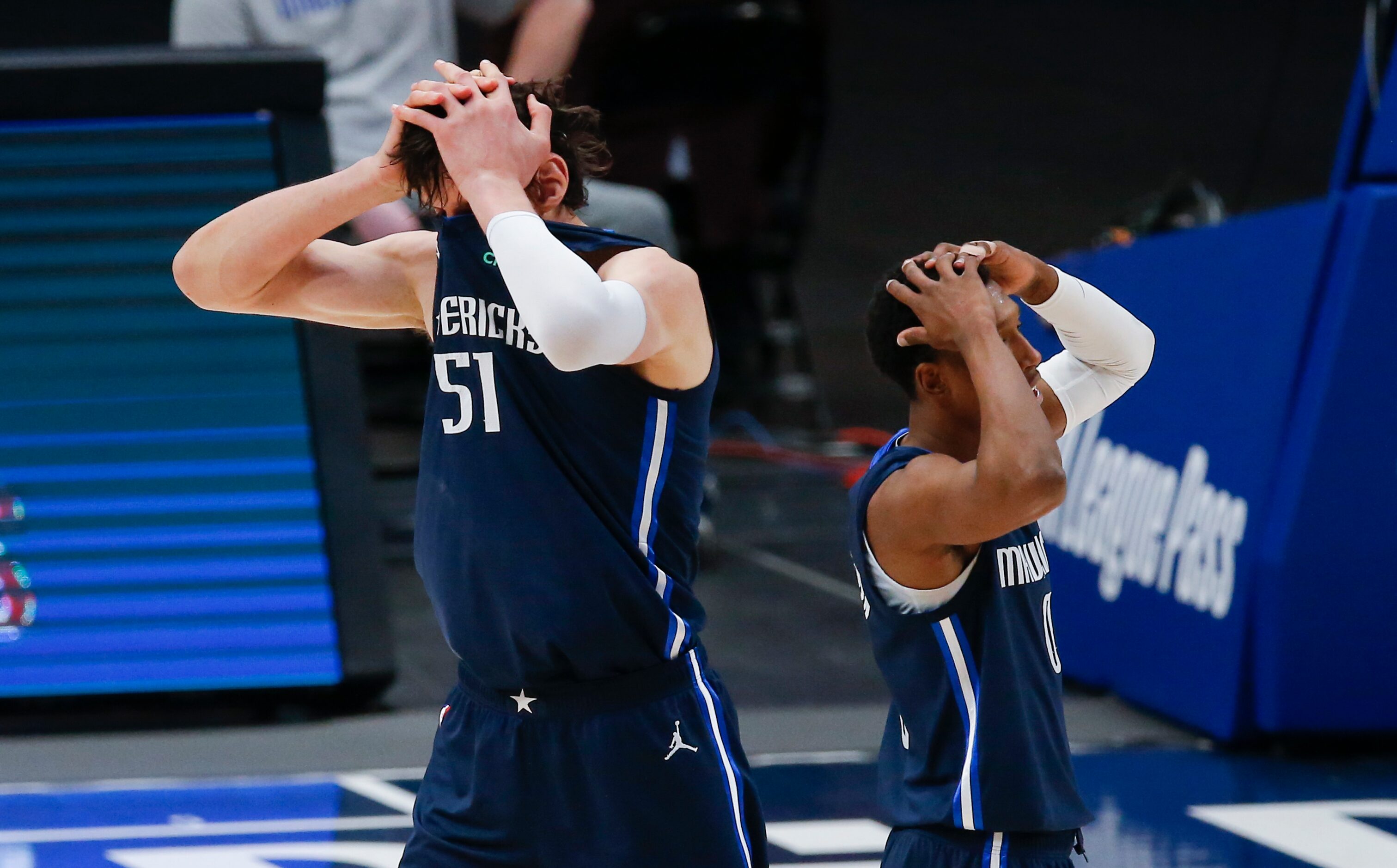 Dallas Mavericks forward Boban Marjanovic (51) and guard Josh Richardson (0) react to a foul...