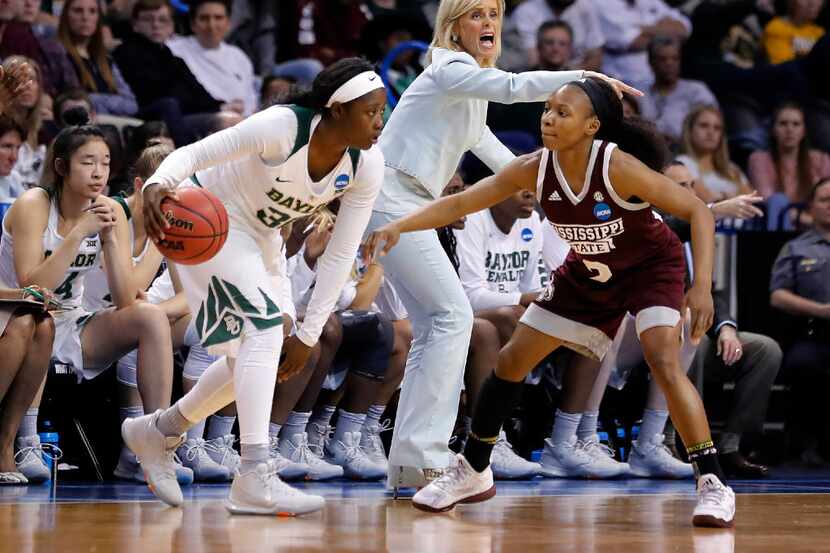 Baylor head coach Kim Mulkey directs her team as Baylor's Alexis Jones (30) drives against...