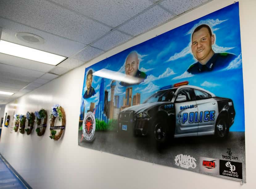 A painting dedicated to the three of the five Dallas police officers who were killed when a...