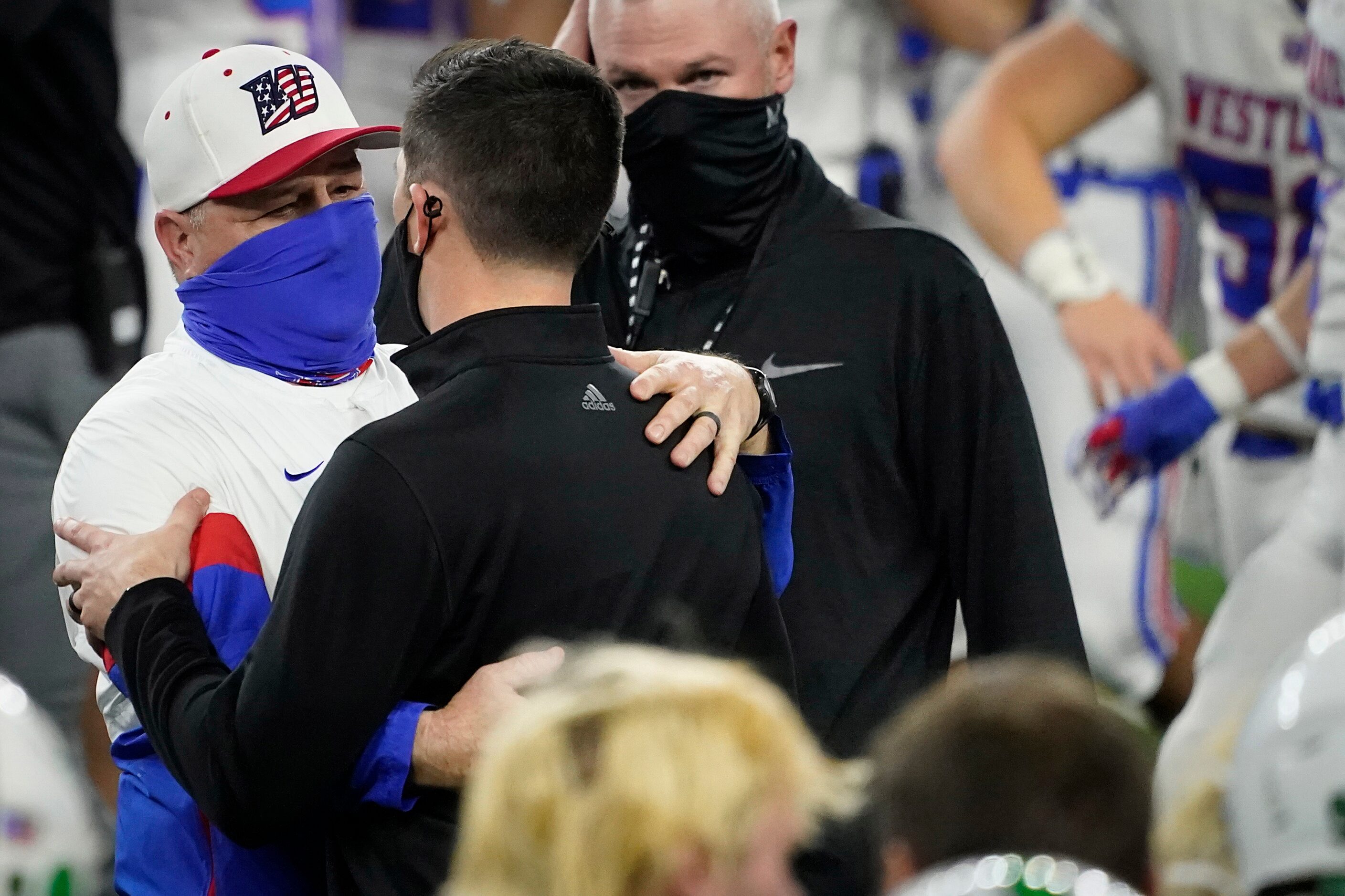 Austin Westlake head coach Todd Dodge hugs his son, Southlake Carroll head coach Riley...