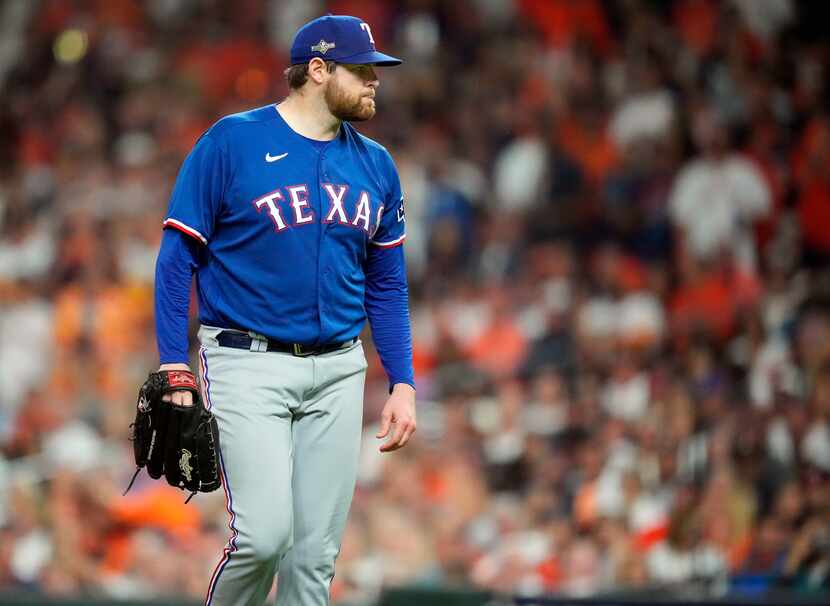 Texas Rangers starting pitcher Jordan Montgomery (52) looks at designated hitter Yordan...