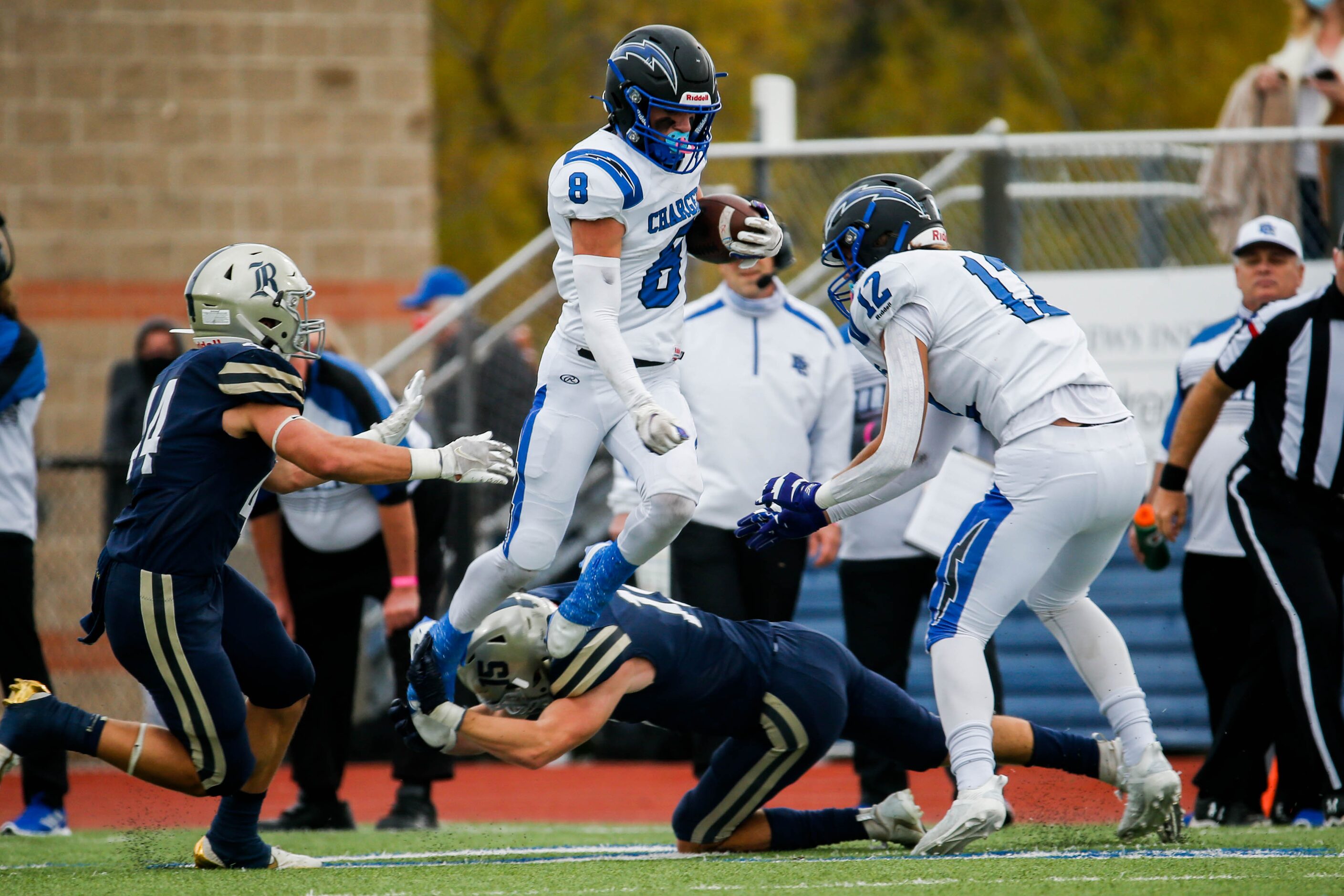 Dallas Christian's Parker Robertson (8) jumps over Austin Regents' Benedict Buerkle (15)...