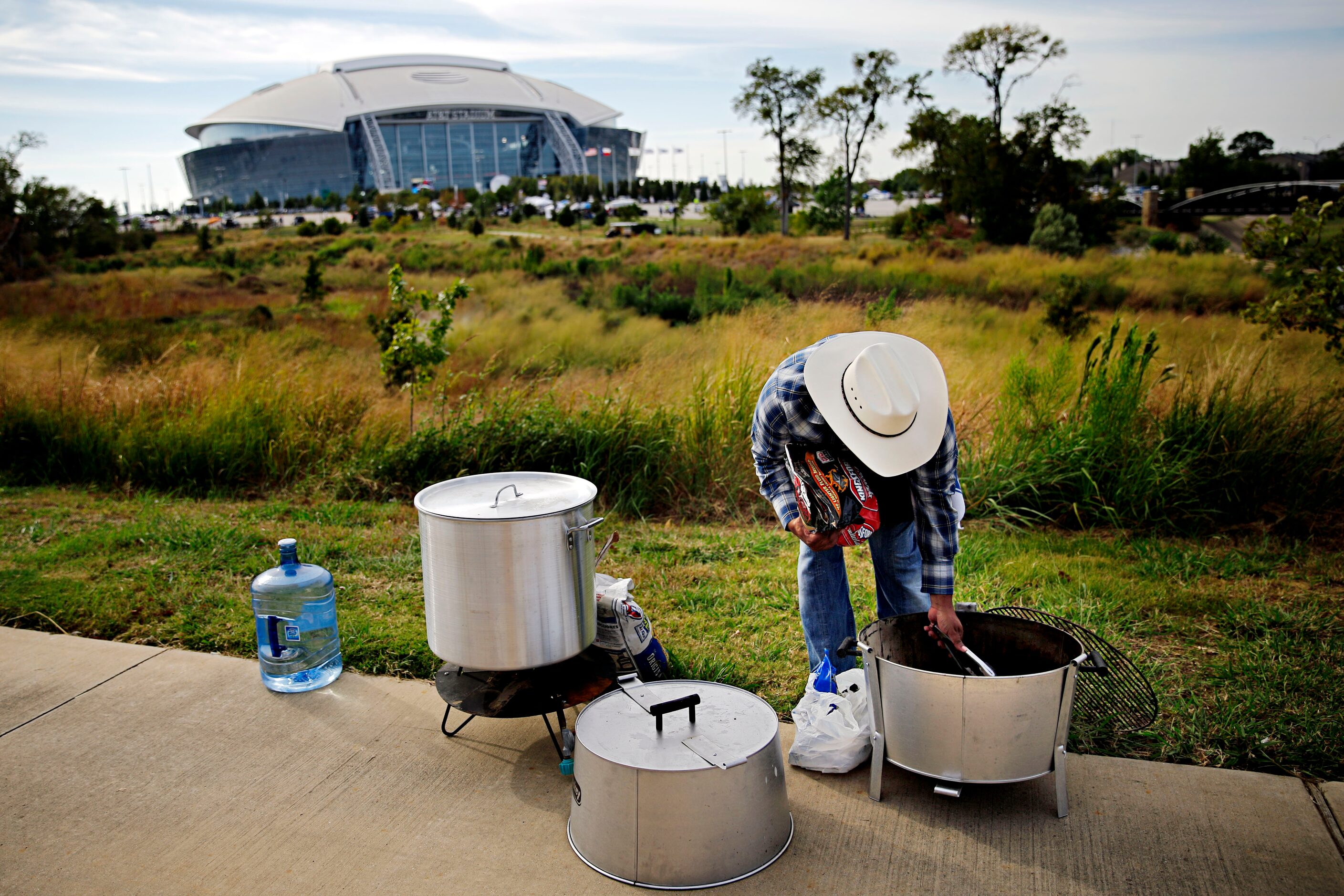 Claude Greene readies a grill before the Dallas Cowboys game against the Washington Redskins...