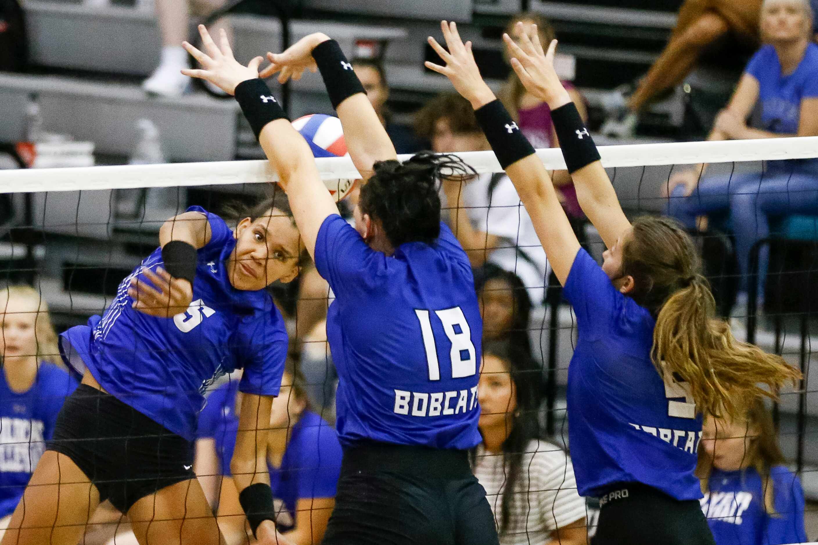 Denton Guyer outside hitter Kyndal Stowers (5) hits into the block of Trophy Club Byron...