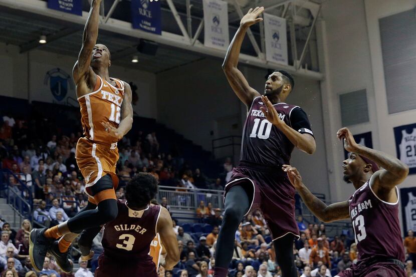 Texas guard Kerwin Roach II (12) goes up for a lay up defended by Texas A&M guard Jacob...