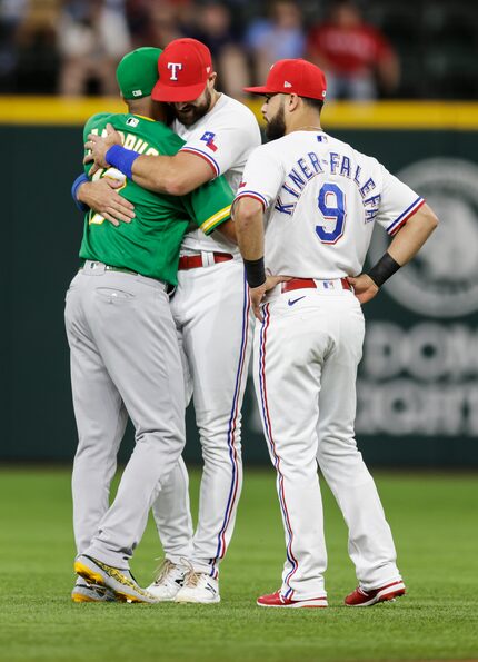 Oakland Athletics shortstop Elvis Andrus, left, greets former teammates Texas Rangers’ Joey...