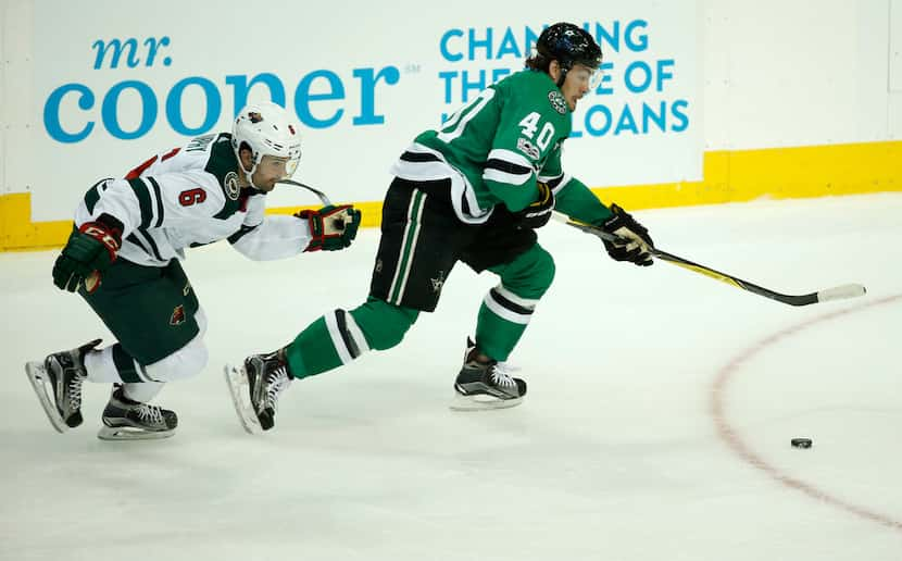 Dallas Stars left wing Remi Elie (40) and Minnesota Wild defenseman Ryan Murphy (6) battle...