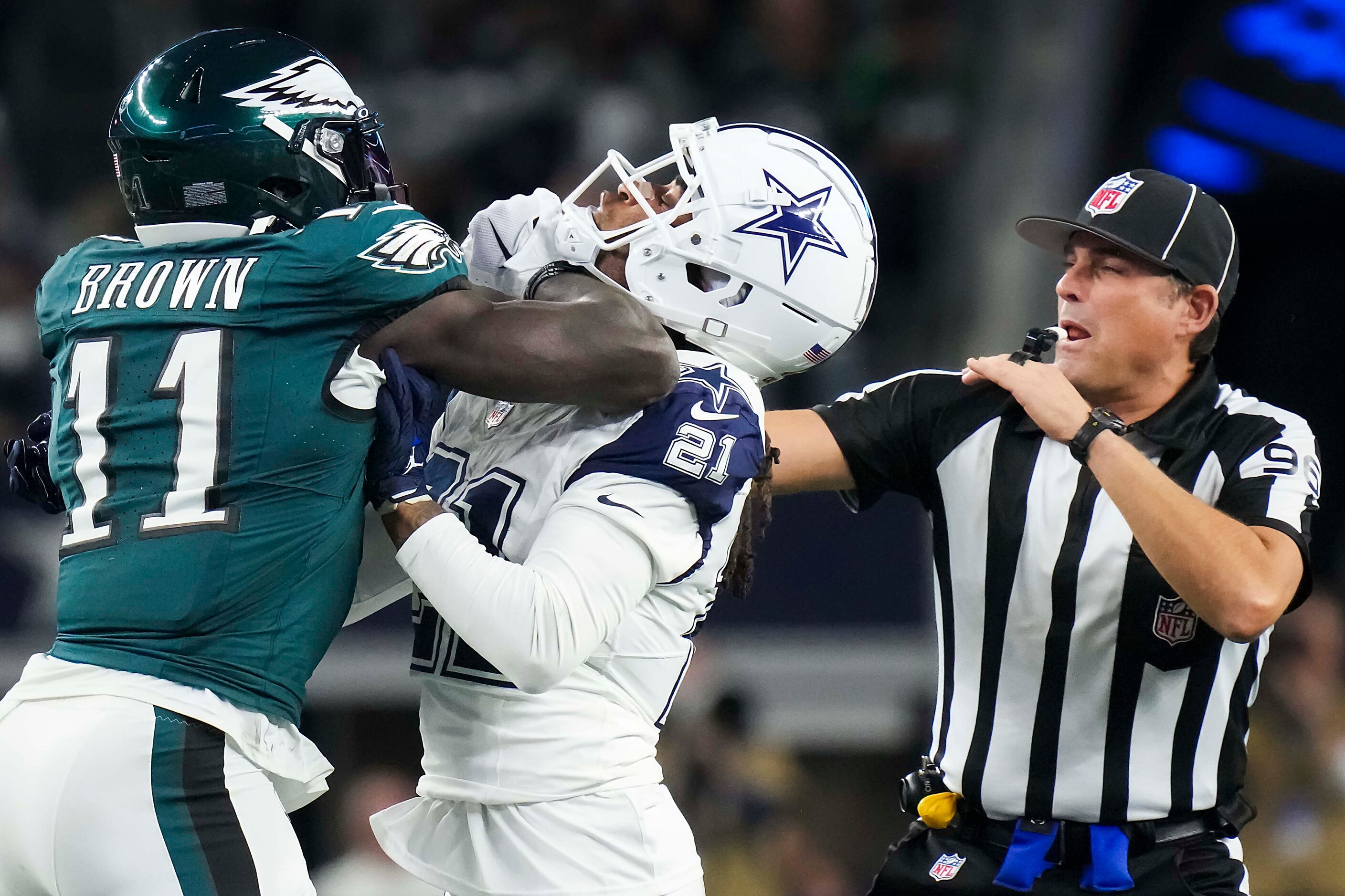 Back judge Matt Edwards (96) tries to separate Dallas Cowboys cornerback Stephon Gilmore...