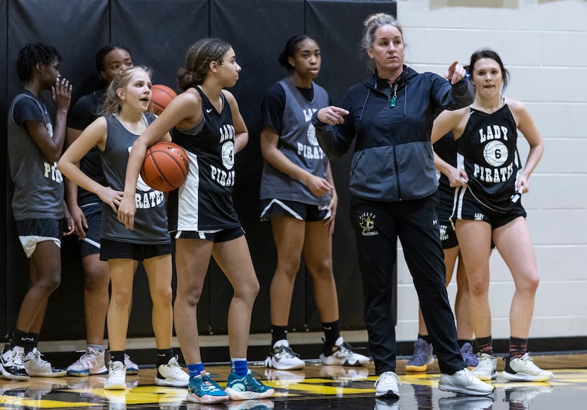 Crandall girls basketball head coach Laura Holmes, right, instructs her players, including...