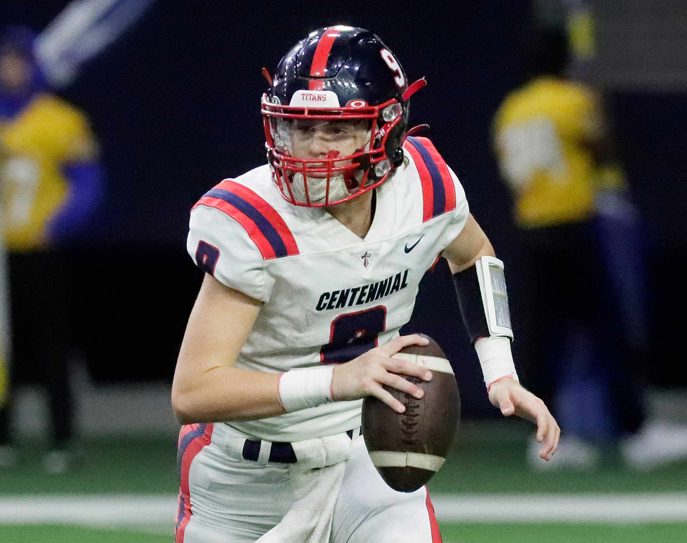 Centennial High School quarterback Jace Patton (9) rolls out during the first half as Frisco...