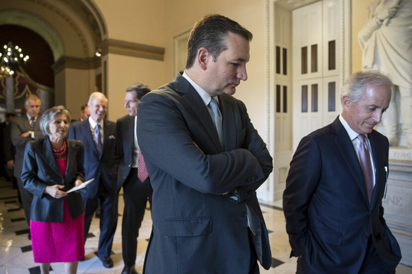 Sen. Ted Cruz, R-Texas (center), walks  to the House Chamber on Capitol Hill in Washington....