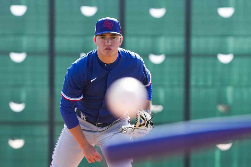 Pitcher Owen White participates in a drill during a Texas Rangers minor league spring camp...