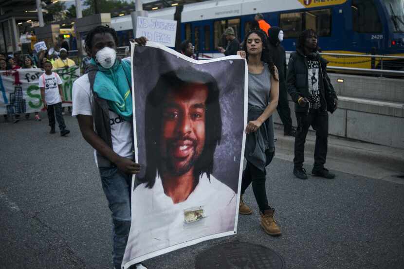 Protestors carry a portrait of Philando Castile on June 16, 2017 in St Paul, Minnesota....