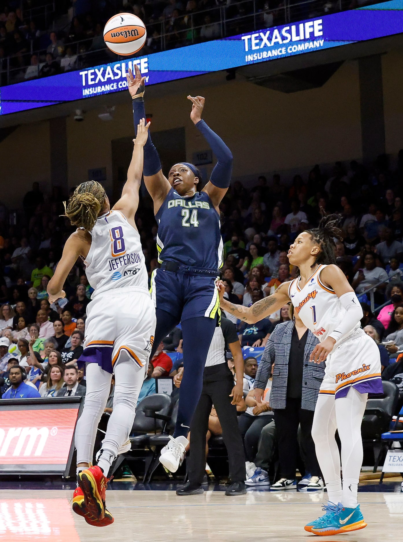 Dallas Wings guard Arike Ogunbowale (24) puts up a shot over Phoenix Mercury guard Moriah...