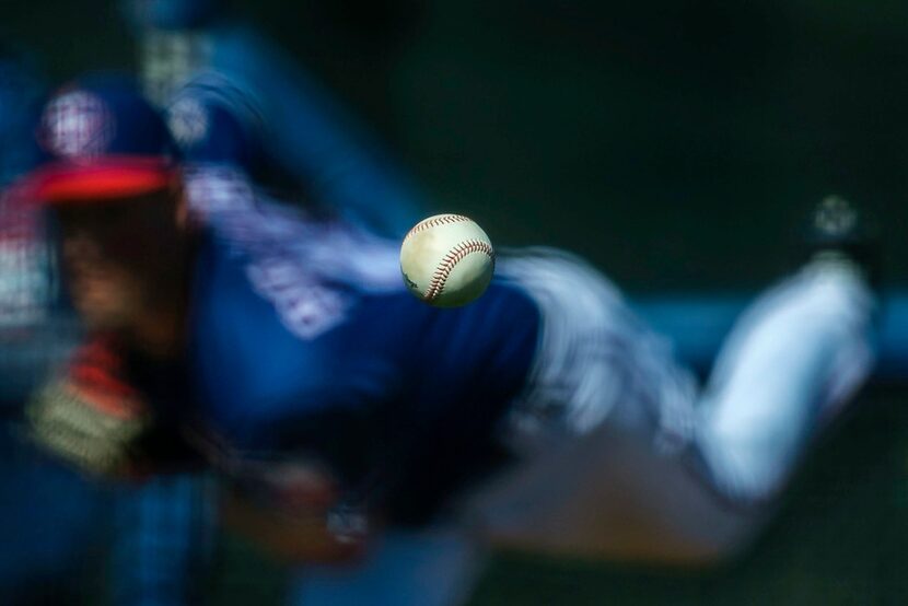 FILE - Texas Rangers pitcher Joe Palumbo throws live batting practice during a spring...