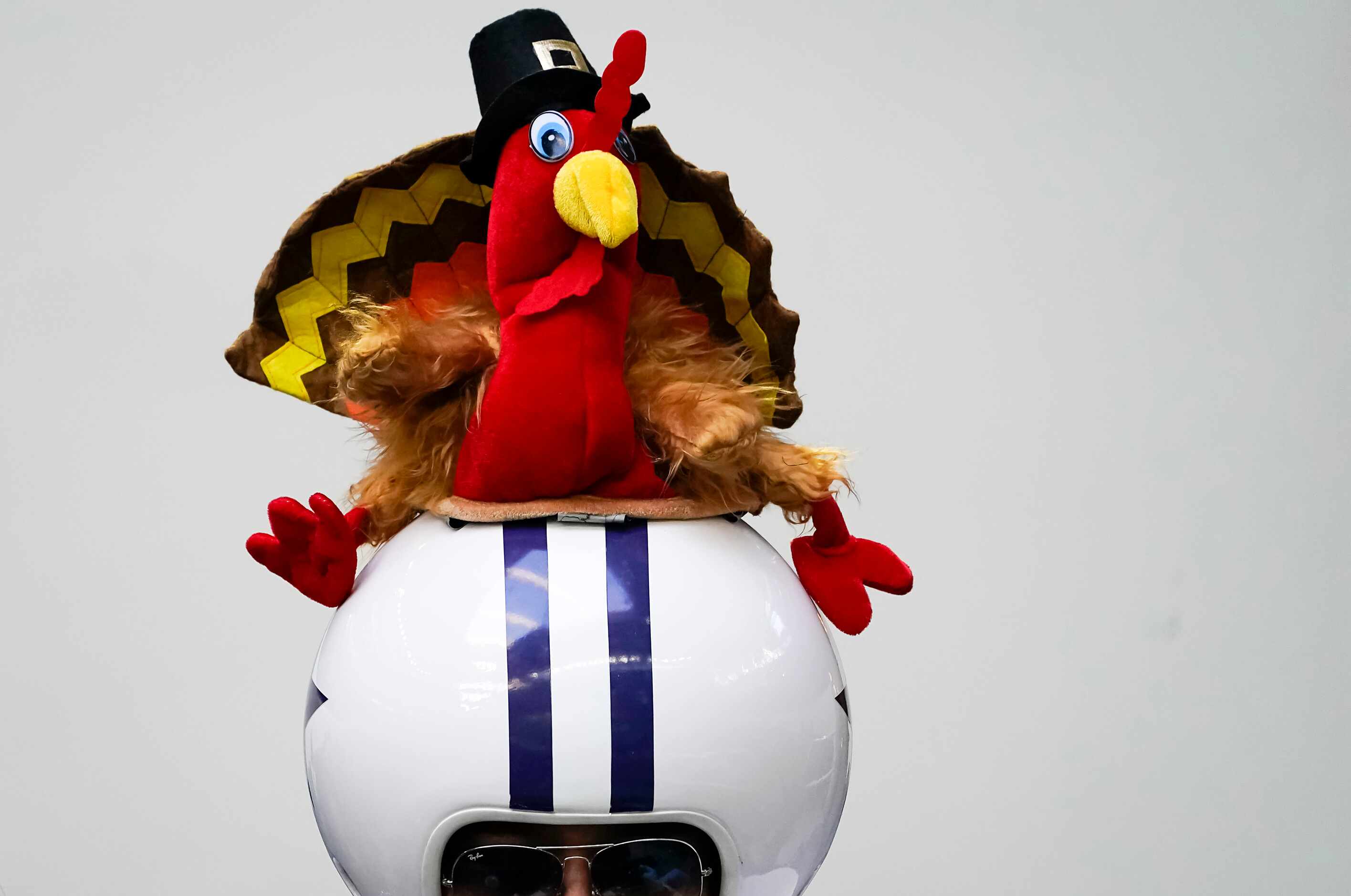 A Dallas Cowboys wears a helmet with a turkey atop it during the first quarter of an NFL...