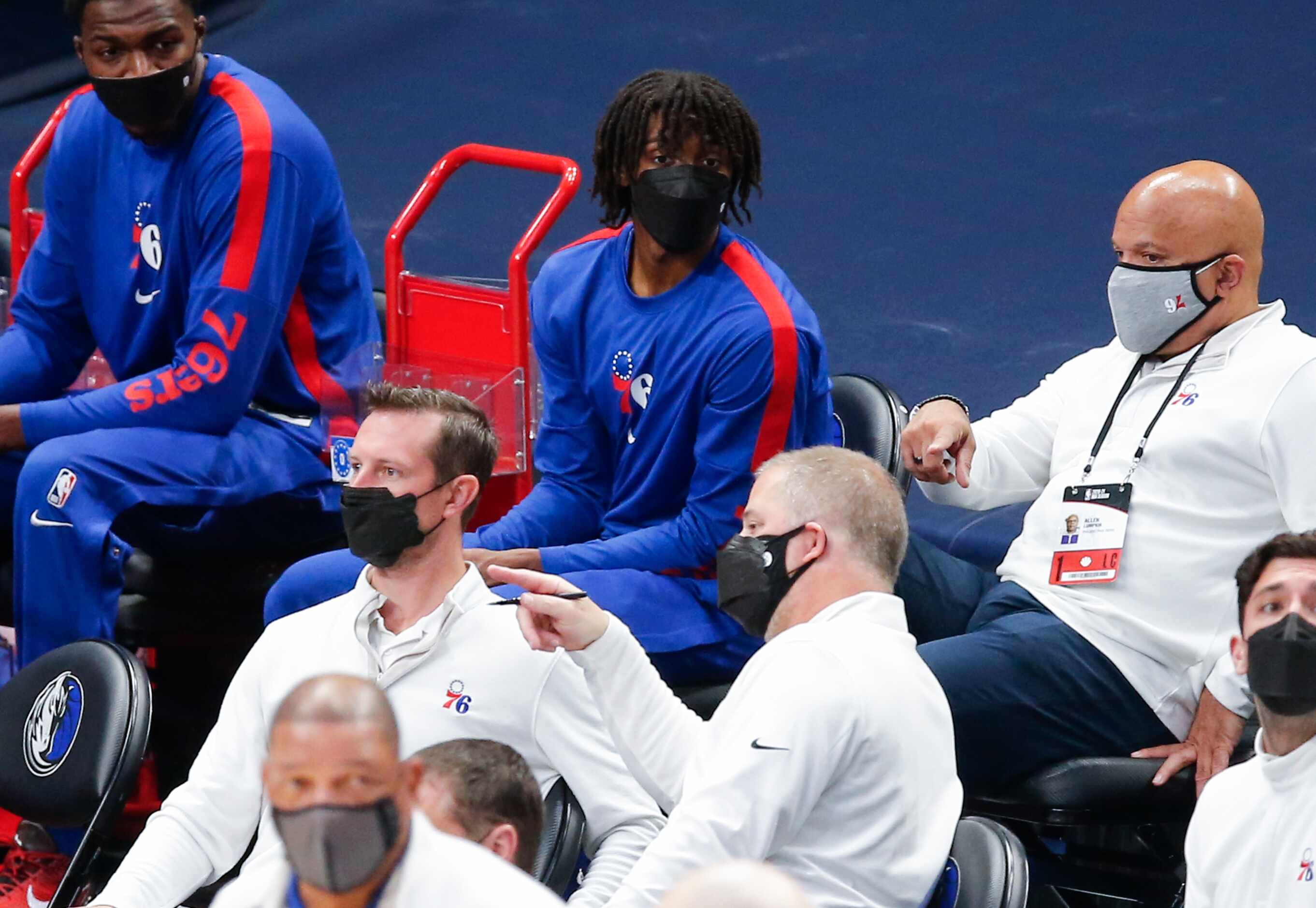 Philadelphia 76ers guard Tyrese Maxey, center, looks on from the bench during the first half...