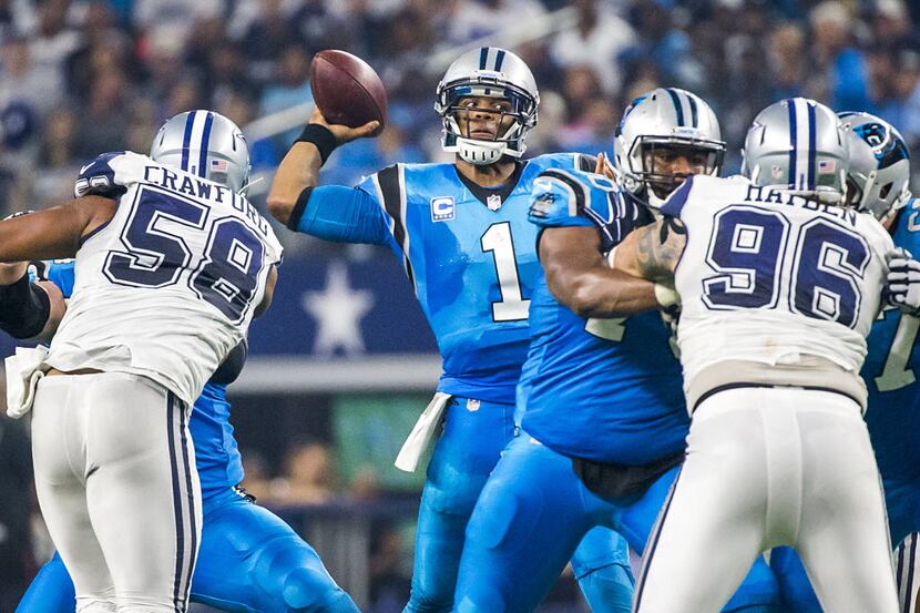 Carolina Panthers quarterback Cam Newton (1) throws a pass under pressure from Dallas...