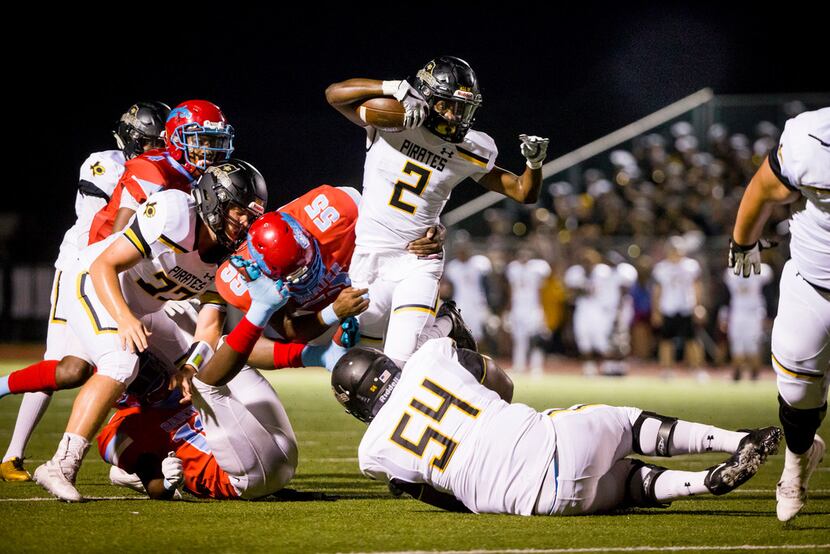 Crandall running back Doneric Rivers (2) carries the ball as he is defended by Carter...