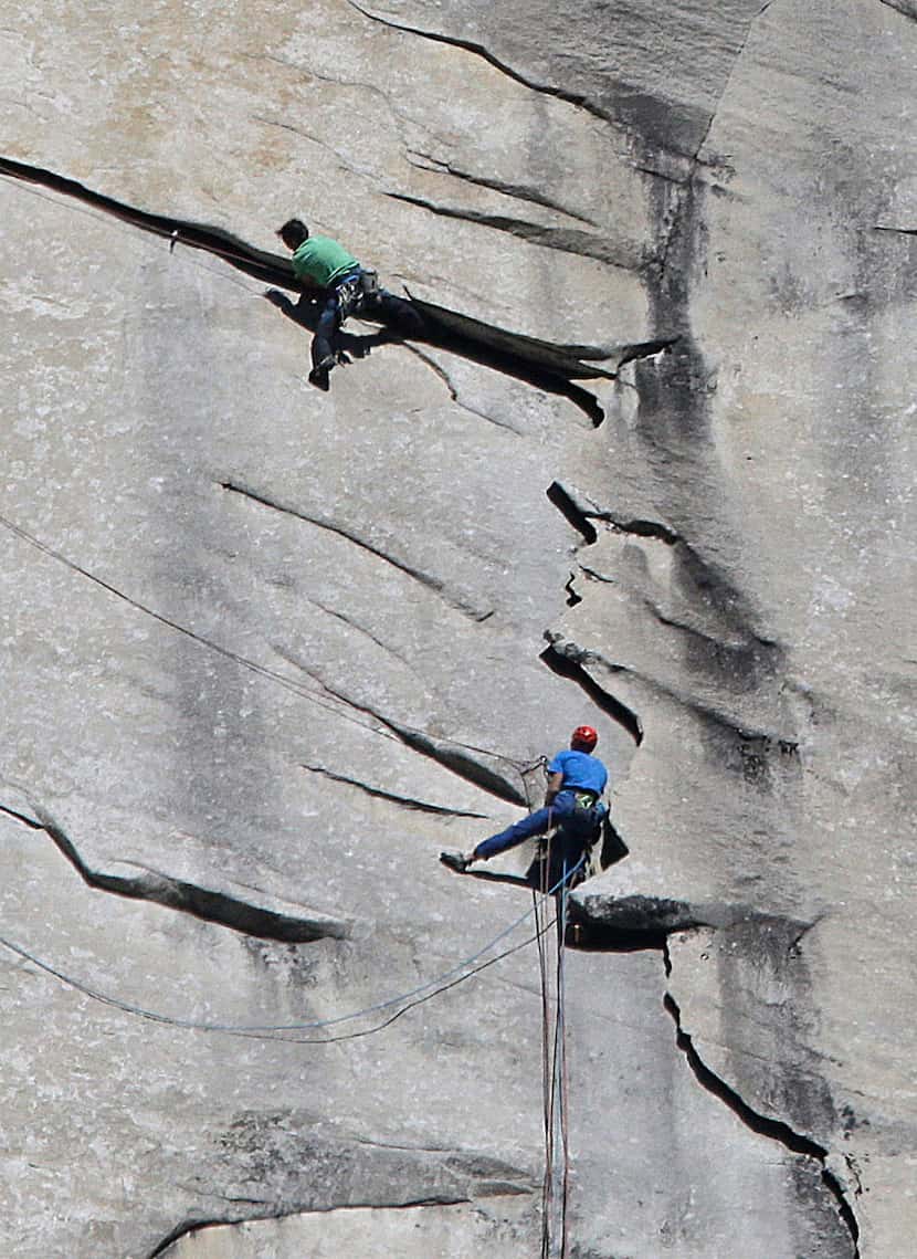 Kevin Jorgeson of California, wearing green, and 36-year-old Tommy Caldwell, wearing blue,...