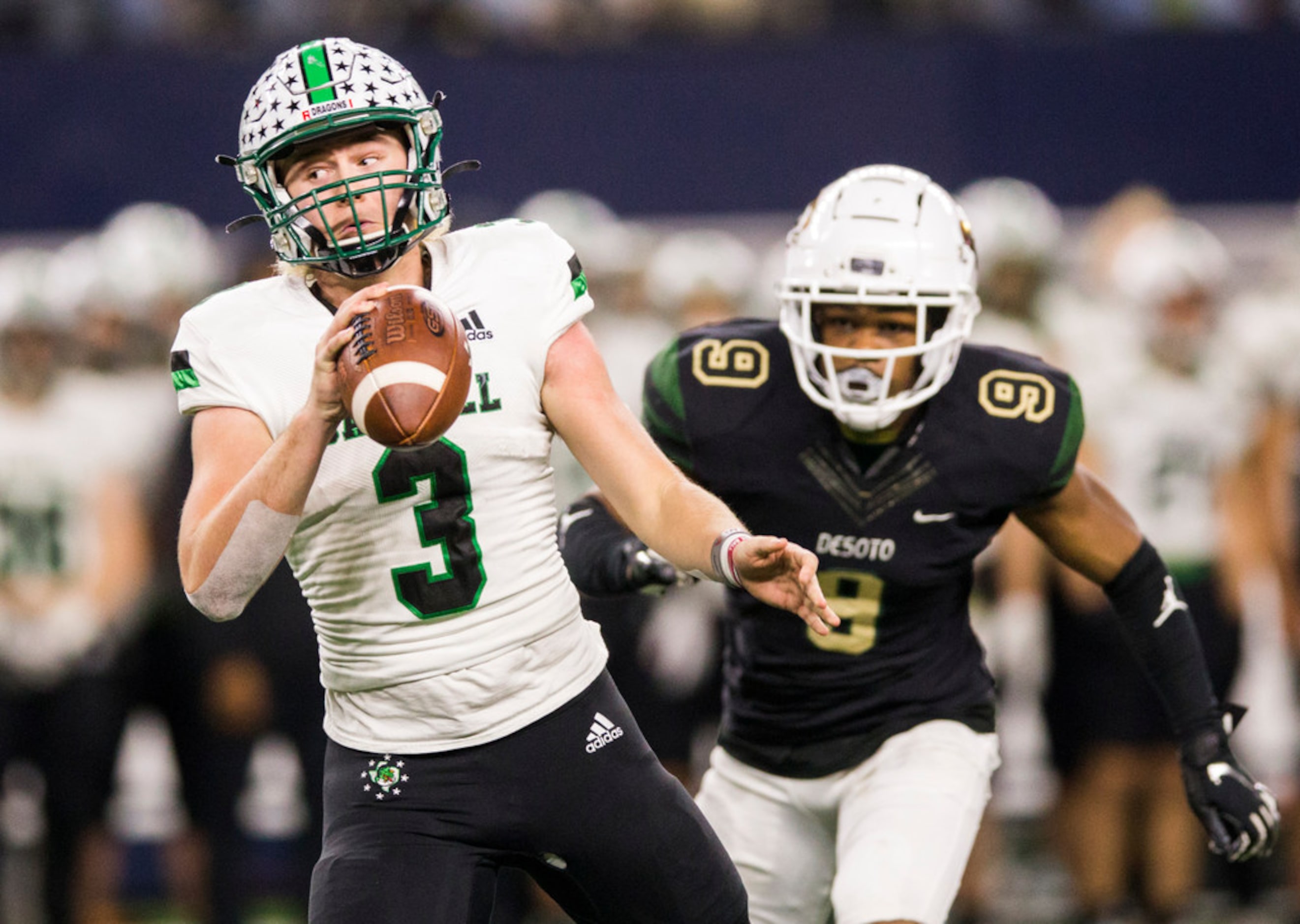 Southlake Carroll quarterback Quinn Ewers (3) escapes a sack attempt by DeSoto linebacker er...