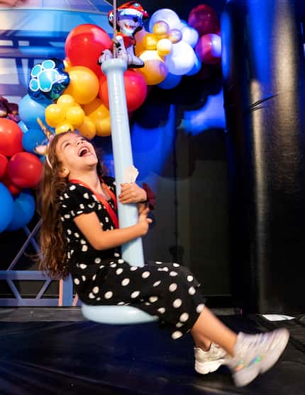 Esther Marques, 4, rides a zip line at 'The Paw Patrol Experience.' It's low to the ground:...