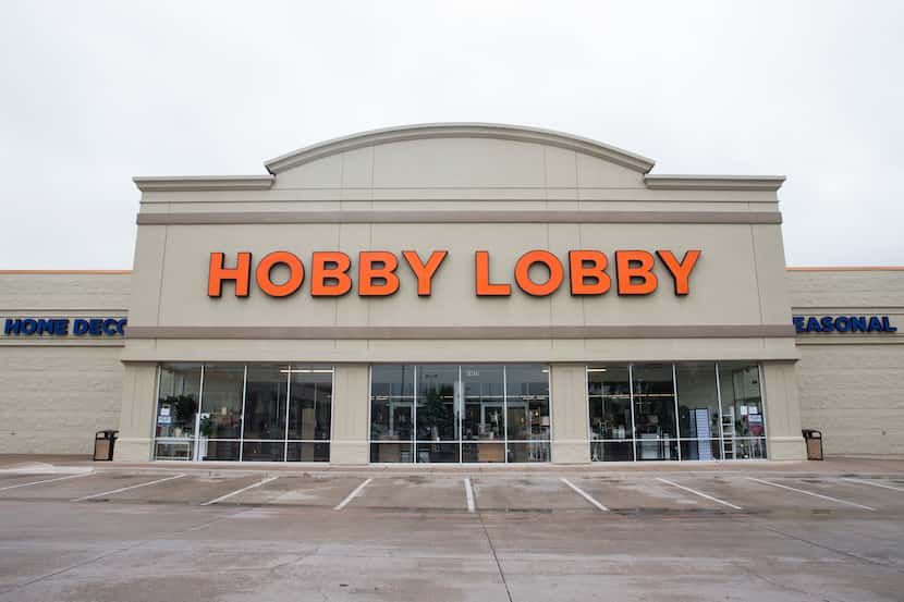 Signs are posted at the front entrance of Hobby Lobby on Preston Road in Dallas. Hobby...