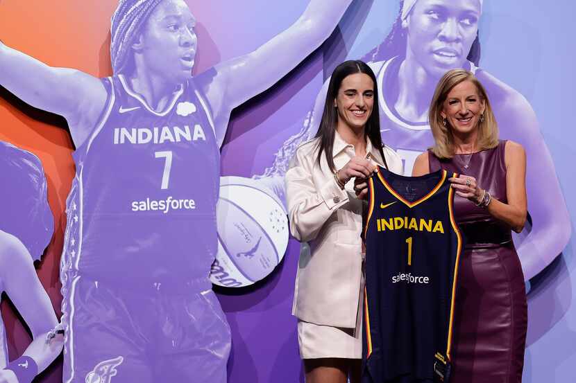 Iowa's Caitlyn Clark, left, poses for a photo with WNBA commissioner Cathy Engelbert after...