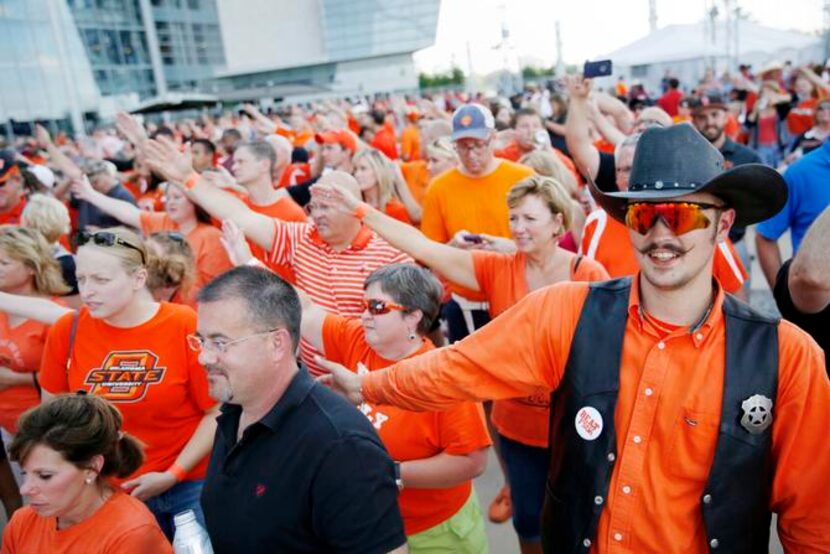 
Alden Armstong (right) of Blanchard, Okla., dressed the part with an orange shirt, orange...