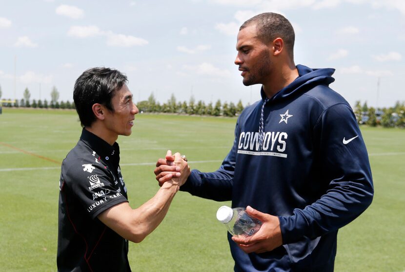 2017 Indy 500 winner Takuma Sato meets Dallas Cowboys quarterback Dak Prescott (4) after...