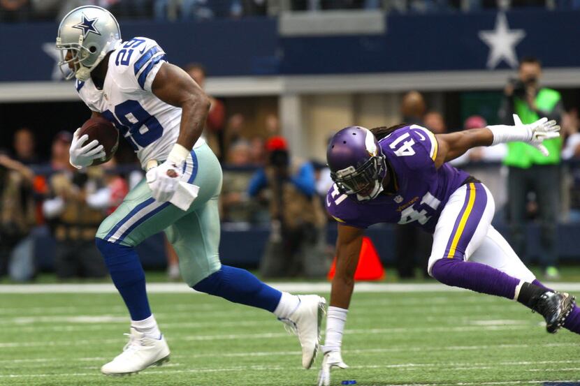 Cowboys running back DeMarco Murray, left, is chased by Vikings safety Mistral Raymond...