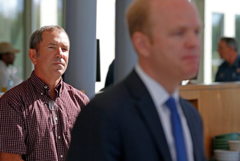 Christina Morris' father, Mark Morris, left, listens to prosecutor Zeke Fortenberry talk...