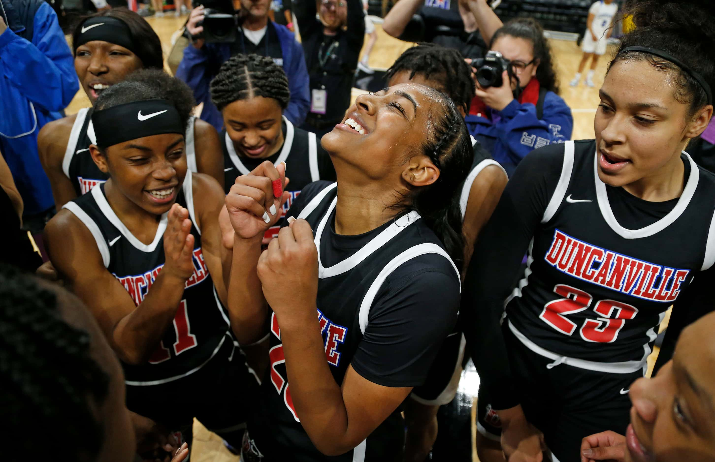 Duncanville guard Deja Kelly #25 celebrates with the rest of the team in a 6A final on ...