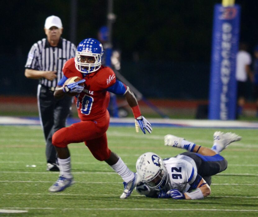 Duncanville running back Roosevelt Richmond evades a Midlothian tackler in Duncanville’s...